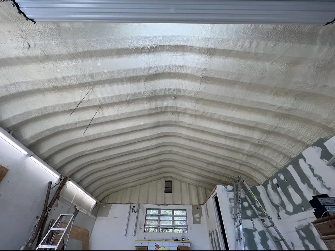 Spray polyurethane foam applied to the underside of a metal roof deck in Joshua